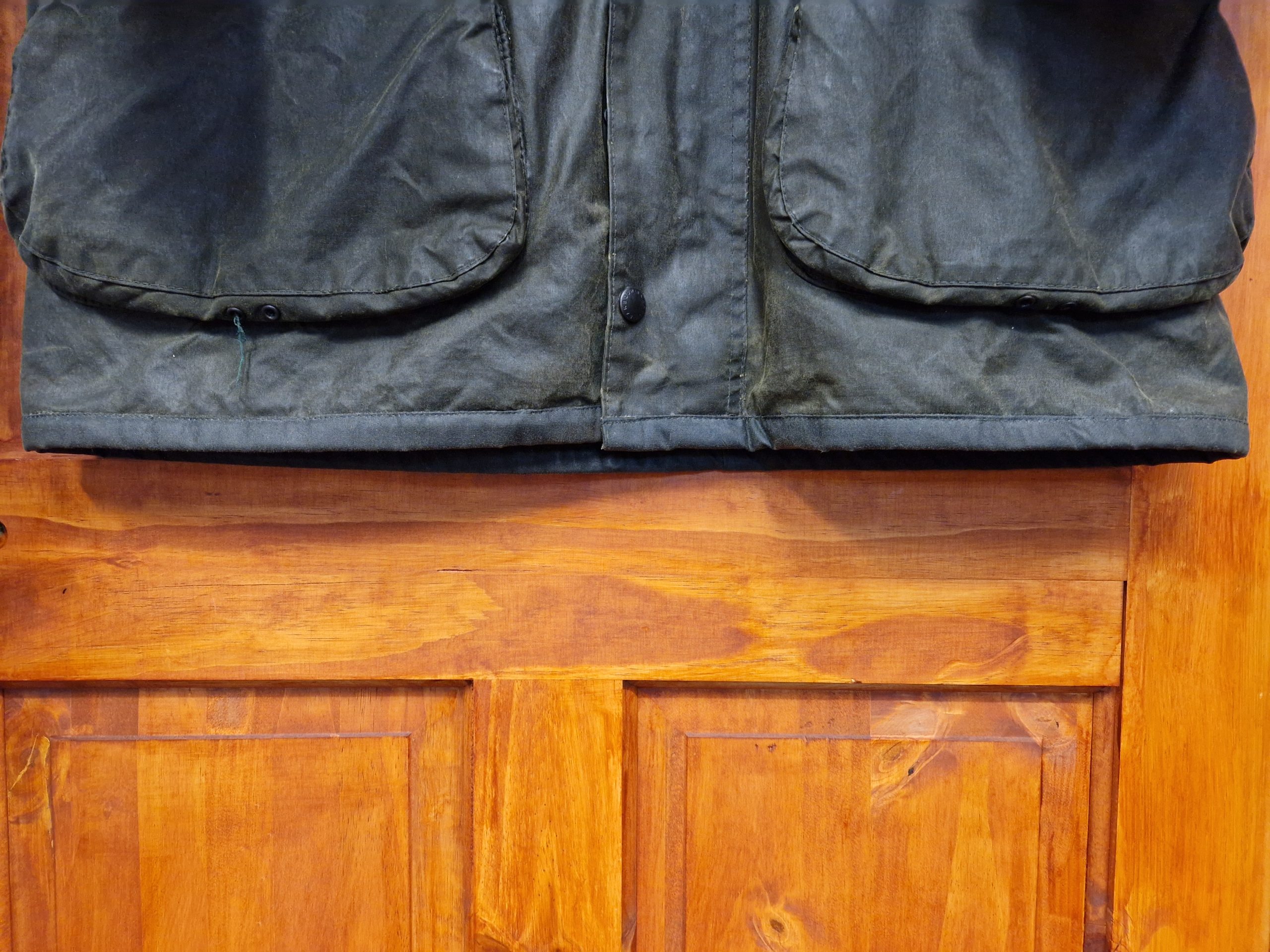 Lower hem of a Barbour wax jacket after specialist edge repair