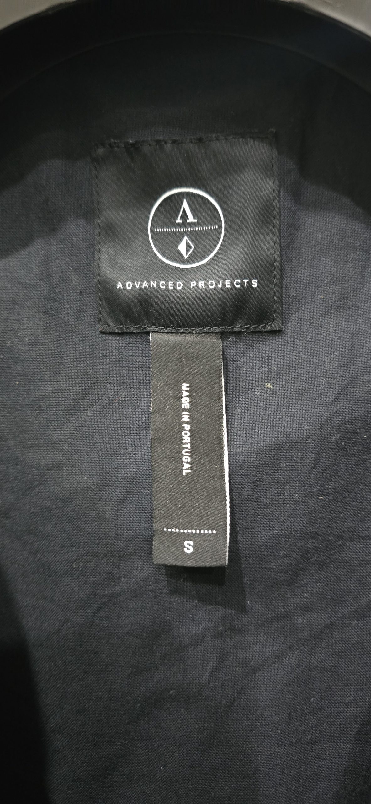 Advanced Projects jacket label photographed on a garment worked on by Wax Jackets Cleaned