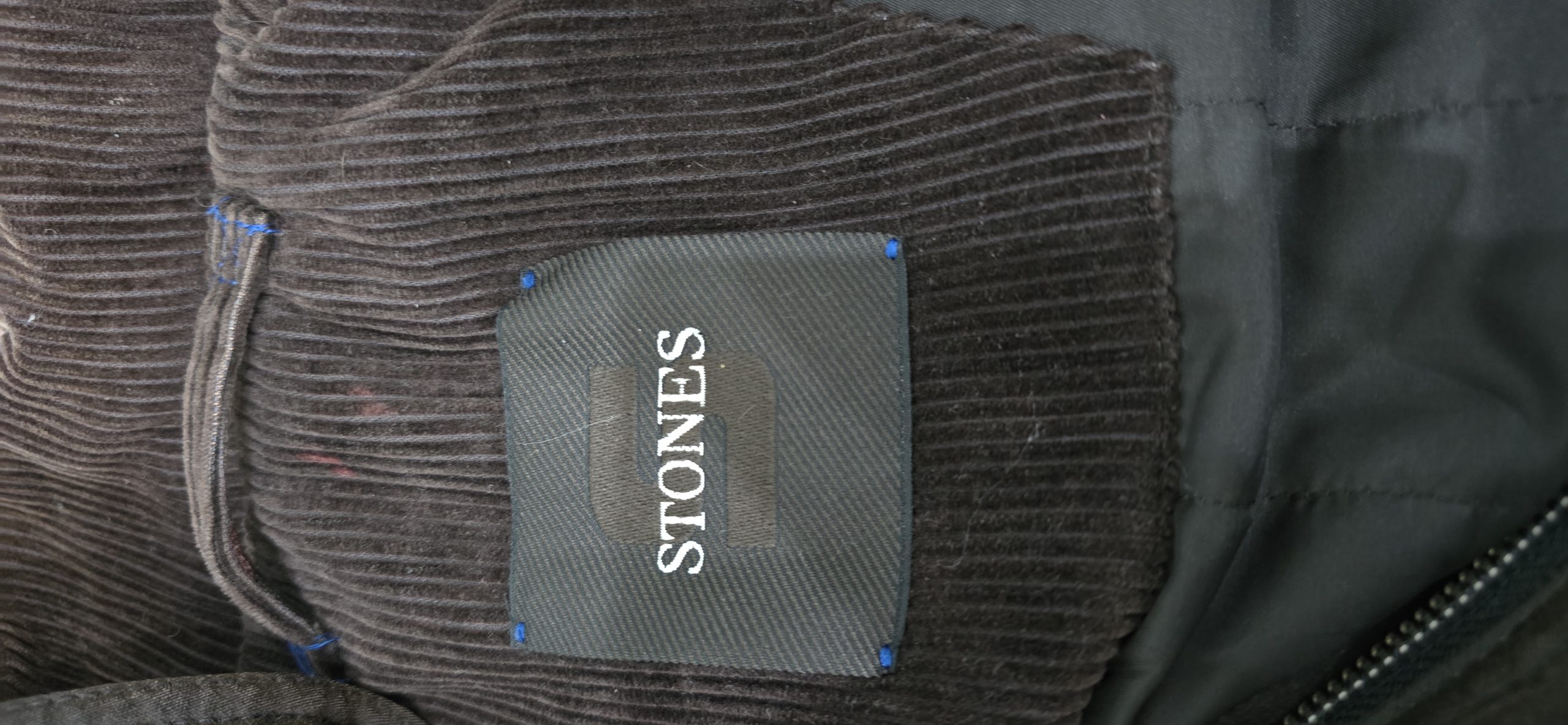 Stones jacket label photographed on a garment worked on by Wax Jackets Cleaned