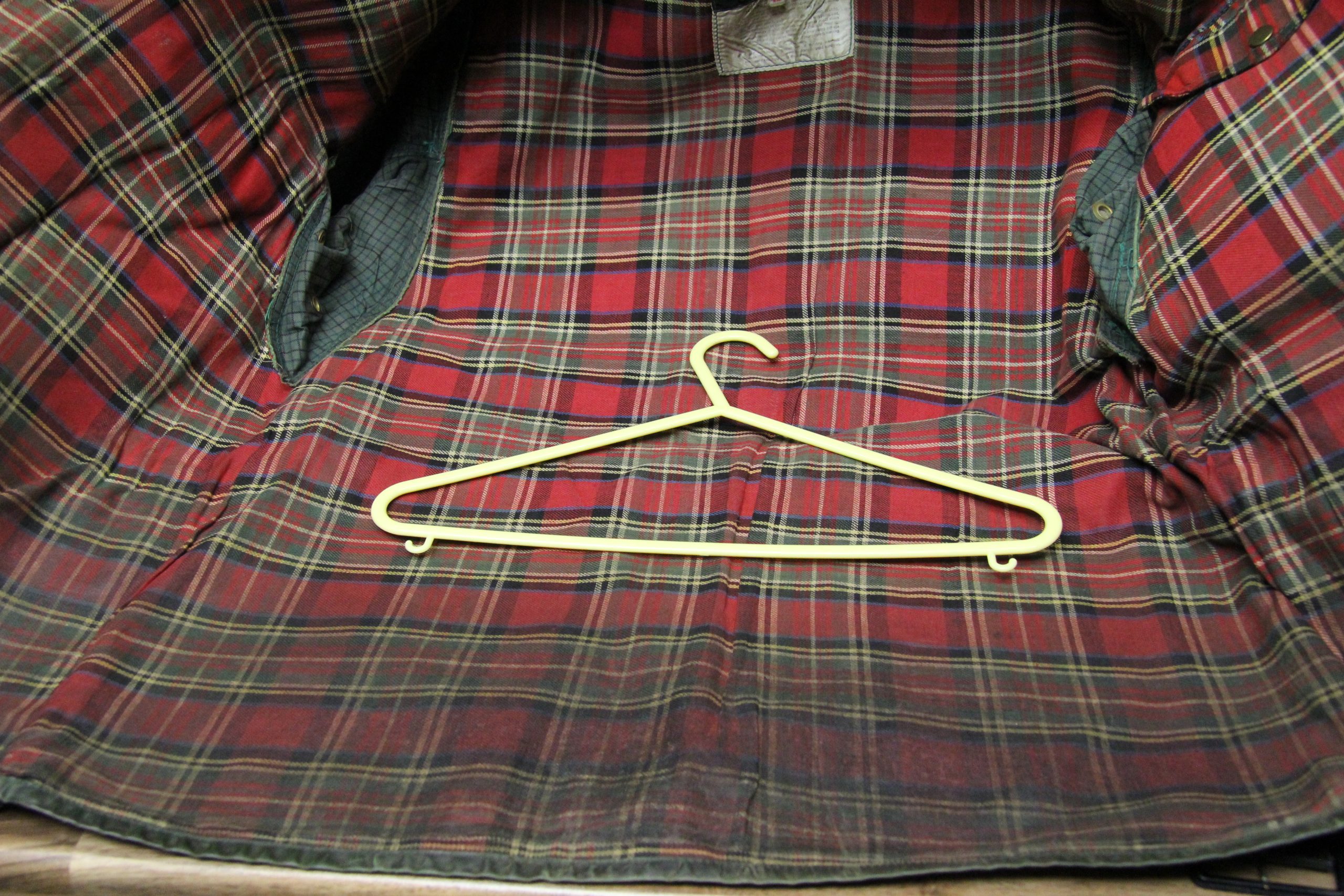 Marked tartan lining inside a Belstaff Trialmaster Professional before cleaning